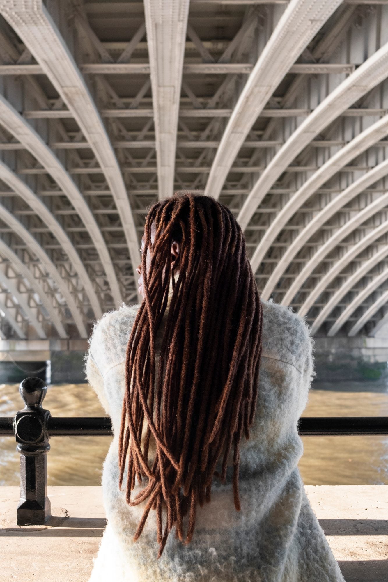 Client with long locs viewed from behind
