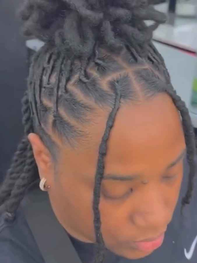 Client's locs sectioned and parted during a styling appointment