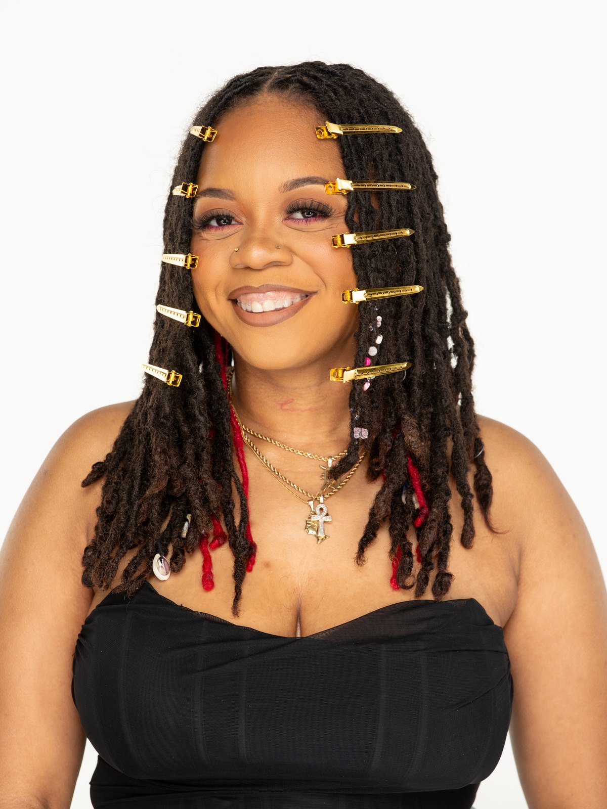 Locs of Love client with sectioned locs and gold clips